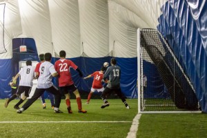 Abbas Hasham fights for position in the box as the corner come in during Gymhana's 5 - 3 defeat by Mozambique Stars.